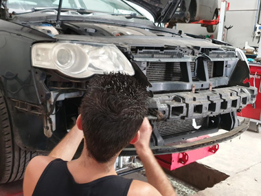 VW Passat has headlights refitted after realignment VW Passat with bumper removed